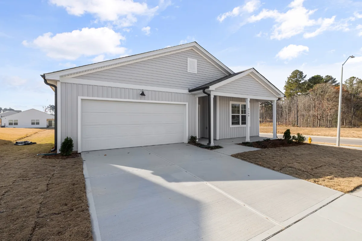 New construction home with freshly poured concrete driveway in the NC Foothills — The Foothills Concrete Company